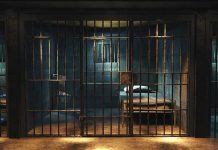 Green River Killer’s Deathbed Secrets: What Remains? Empty prison cell with metal bars and bed.