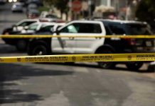 How Radical Preacher’s Cult Drove Mother’s HORRIFYING Crime Police tape blocking street with patrol cars.