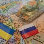 Ukraine War EDGES Closer to Peace Toy tank on map with Ukraine and Russia flags.