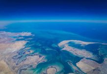 Aerial view of coastline and ocean.