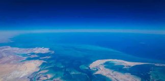 Aerial view of coastline and ocean.
