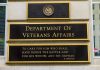 VA EXPOSED: Veterans Used As Drug Guinea Pigs Department of Veterans Affairs building sign with quote.