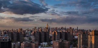 Cover-Up Accusations: Mamdani’s Team Under Fire A panoramic view of New York City skyline during sunset with clouds