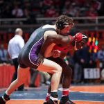 High School Hero’s DARK Secret Exposed Two wrestlers competing on a mat during a match