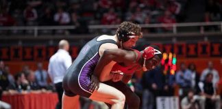 High School Hero’s DARK Secret Exposed Two wrestlers competing on a mat during a match