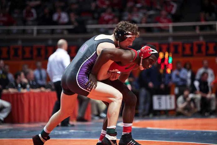 shutterstock_135776582.jpg Two wrestlers competing on a mat during a match