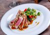 Plated seared tuna with a fresh salad on the side