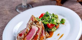 Plated seared tuna with a fresh salad on the side