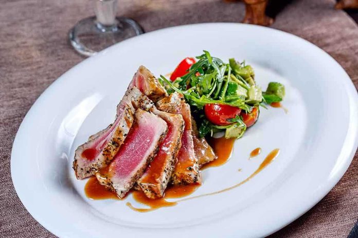 Plated seared tuna with a fresh salad on the side