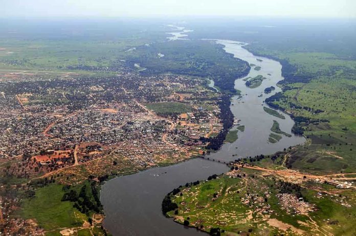shutterstock_79424332.jpg Aerial view of a river winding through a town and green fields