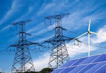 Left-Wing Extremists TRIGGERED Citywide Blackout Power lines, solar panels, and wind turbine against sky.