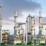 Routine Shift Turned Fatal Industrial plant with metal towers and pipes.