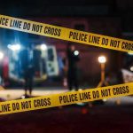 Surgeon Linked To Brutal Killings Yellow police tape in front of crime scene.