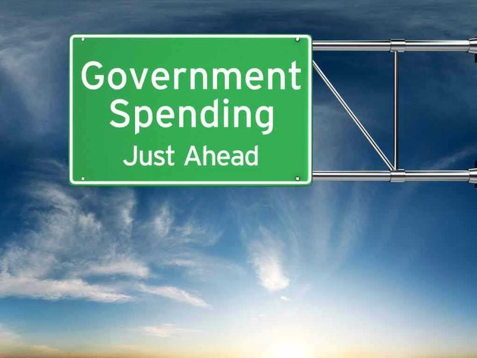 306579131 Green road sign: Government Spending Just Ahead.