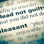 American Law Firms Under Siege plead not guilty highlighted in a dictionary.