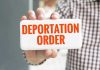 Trump Supporter’s Immigration Nightmare Hand holding sign with Deportation Order text.