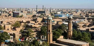 Aerial view of a city featuring traditional buildings and minarets