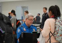 Airport NIGHTMARE: Democrats Block Homeland Security Budget TSA agent checks passengers documents at airport security.