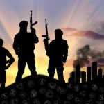 Nonprofits Funding U.S. Terrorists – Finally EXPOSED Three armed silhouettes near a smoky city skyline.