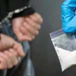 Senator’s Arrest Sparks Cartel Shockwave Person handcuffed, police holding bag of white substance.
