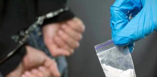 Senator’s Arrest Sparks Cartel Shockwave Person handcuffed, police holding bag of white substance.