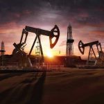 This State Has Deadliest Workplace Reputation Oil rigs operating at sunset in a desert landscape.