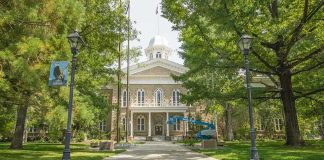 Rogue Candidate’s Shocking Prison Camp Proposal Historic stone building surrounded by trees and lampposts.