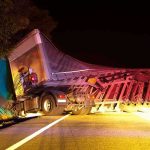 Drug-Driven Crash KILLS Three—Illegal Trucker Cuffed An overturned truck on the side of the road at night with emergency lights