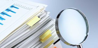 Word Games Rewrite Pregnancy Law? Stack of documents with a magnifying glass beside it