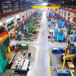 Power-Hungry AI Fuels Sticker Shock Aerial view of a large industrial workshop filled with various machinery and equipment