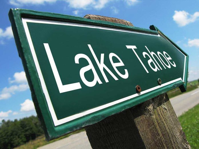 A green directional sign pointing to Lake Tahoe against a blue sky