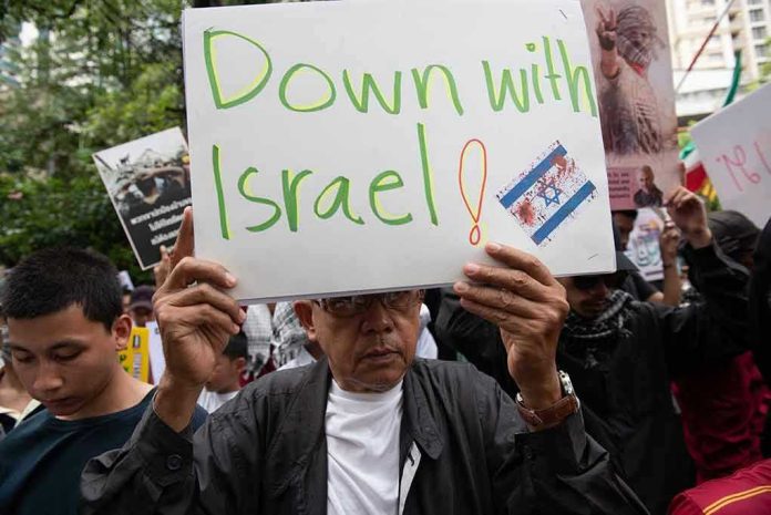 Person holding Down with Israel sign at protest.
