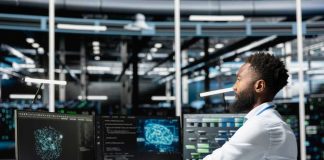 Pentagon Hands Grok the War Keys A man working at a computer workstation with multiple screens displaying data visualizations
