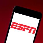 DOJ Targets NFL’s Paywall Play ESPN logo on smartphone screen against red background