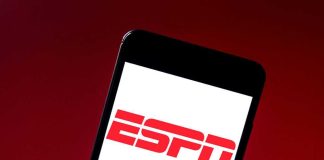 DOJ Targets NFL’s Paywall Play ESPN logo on smartphone screen against red background