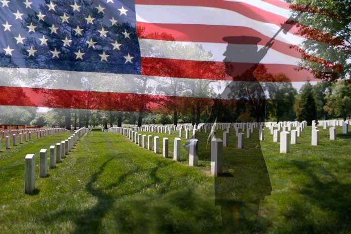 shutterstock_109165295 A military cemetery with white gravestones and an American flag overlay, featuring a soldier silhouette