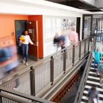 Dad’s Gun Gift Triggers Murder Conviction Students walking through a modern school hallway and stairwell