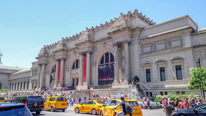 Grand museum facade with columns and busy street with taxis