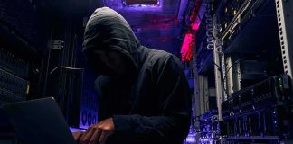 AI Agent Breaks Out — Hits Hugging Face Hooded person using a laptop in a dark server room