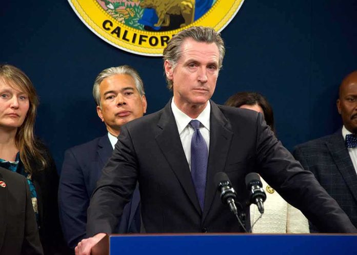 Man in suit at podium with microphones during press conference