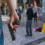 Hawaii Court Guts Gun Right person holding a handgun in a public square