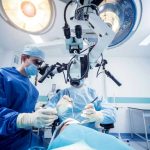 Snake Parasite Jumps Species — Into Her Head Surgeons performing operation under surgical microscope