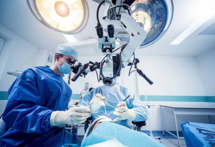 surgeons-performing-brain-surgery1805652622jpg Surgeons performing operation under surgical microscope