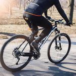cyclist riding a mountain bike on a paved path