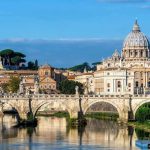 St. Peter's Basilica behind Ponte Sant'Angelo over the Tiber River