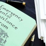 Judge Hands DSA Millions — Family Stunned Notebook titled Emergency Rental Assistance Program beside papers and pen