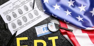 Border Killings Tied To ‘Terror’ Crackdown FBI letters with fingerprint sheet, badge, magnifying glass, and US flag