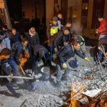 Flood Time Bomb Halts Tibet Rescues Rescue workers search through rubble at night