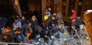 Flood Time Bomb Halts Tibet Rescues Rescue workers search through rubble at night