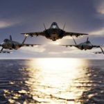 Greenland Ultimatum Shocks NATO Five jets flying low over the ocean at sunset.